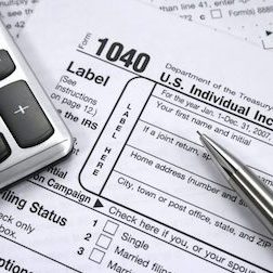 1040 tax form, pen and calculator